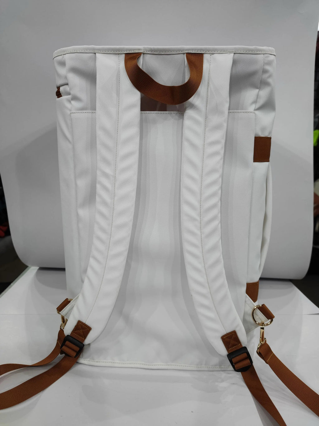 Back view of the Caribbean Convertible Duffel, showcasing its white fabric, adjustable straps for backpack use.